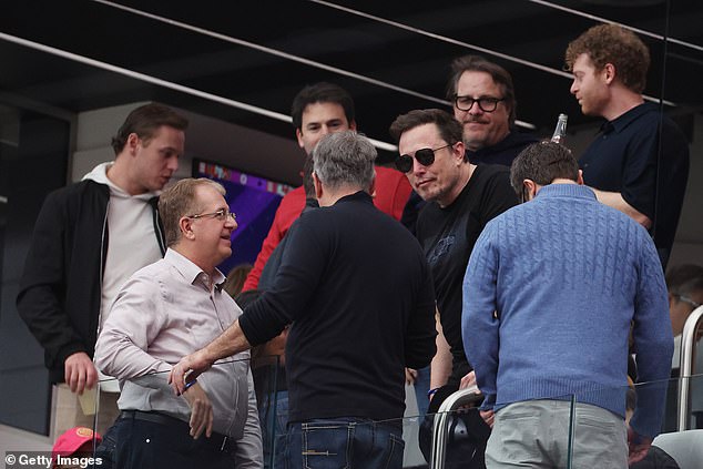 The 52-year-old billionaire speaks to familiar faces in a private box upon his arrival at the stadium.
